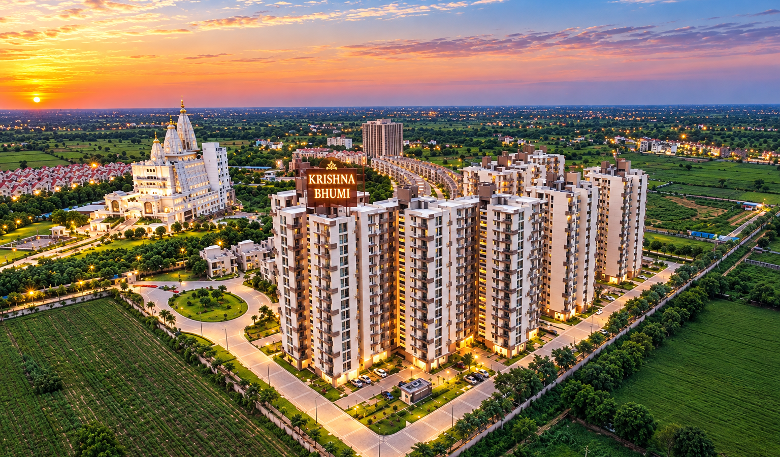 Aerial view of Krishna Bhumi serviced residences and Vrindavan Chandrodaya Mandir illuminated at sunset.