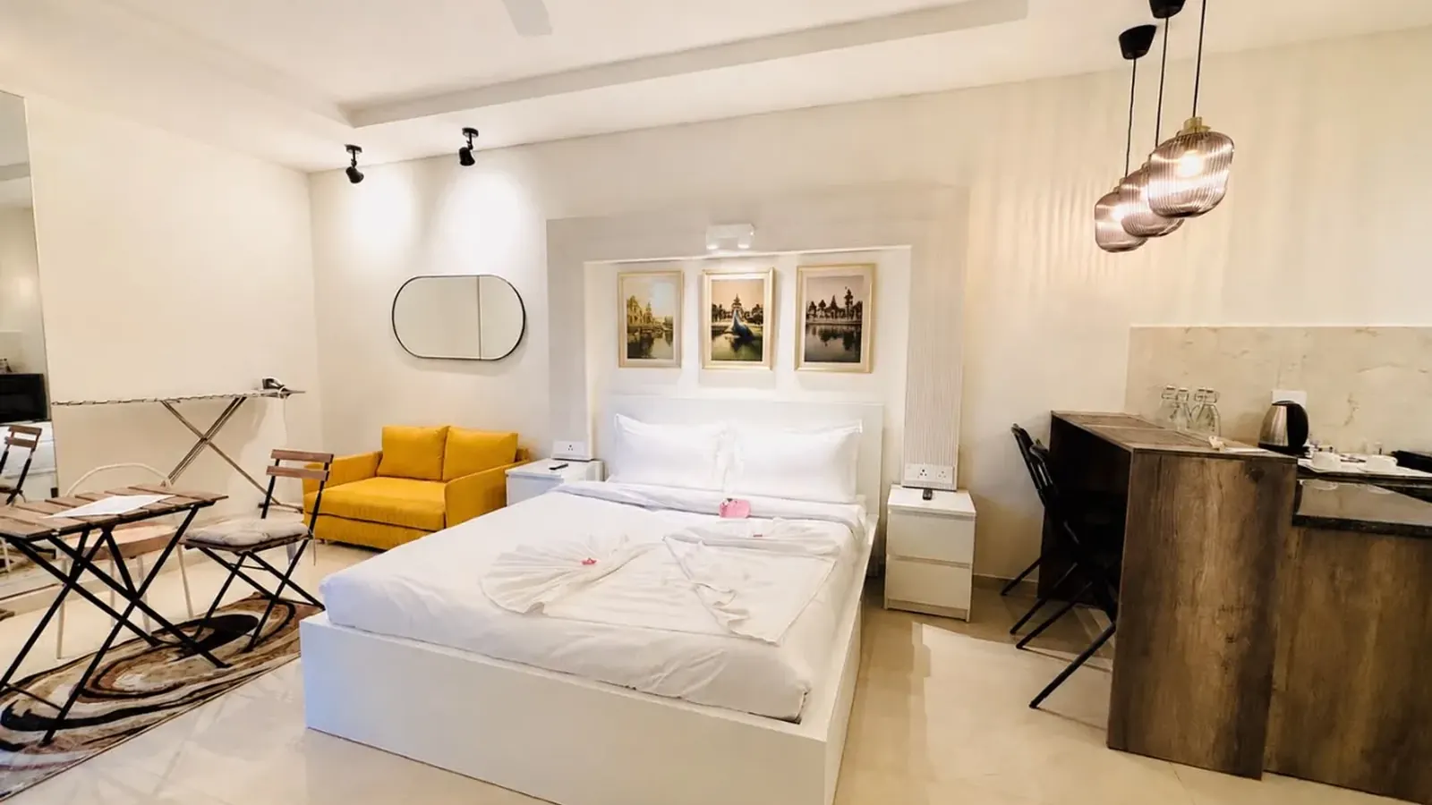 A furnished studio at Vrindavan Staycation: bed, sofa and kitchenette in one room